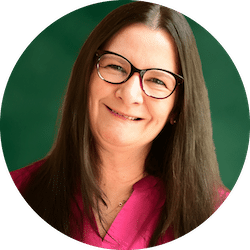Woman with long brown hair and a pink dress